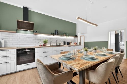 a kitchen with a wooden table with chairs around it at Apartment Pyramidenblick in Karlsruhe