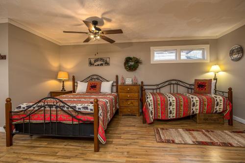 a bedroom with two beds and a ceiling fan at Rustic Ranch by American Patriot Getaways in Waldens Creek