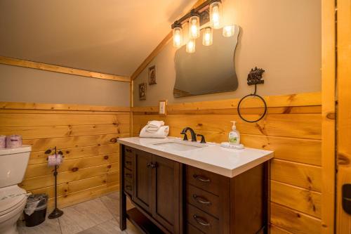 a bathroom with a sink and a mirror on the wall at Rustic Ranch by American Patriot Getaways in Waldens Creek