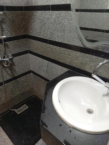 a bathroom with a white sink and a shower at ميراج باي اكوا بارك in Hurghada