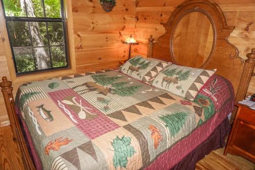 a bedroom with a bed in a log cabin at Seclusion by American Patriot Getaways in McCookville
