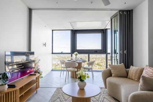 a living room with a couch and a table at Queen's Wharf Lv 51 - 2Bedroom Skybound Sanctuary on Casino in Brisbane