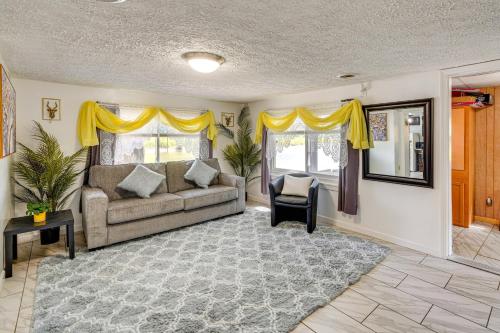 a living room with a couch and yellow curtains at Cozy House on Meadowbrook Lake Serene, Scenic! in Stow