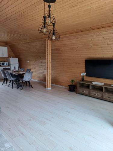 a large room with a flat screen tv and a table at COLȚ DE RAI - A Frame in Corbi
