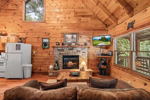 a living room with a fireplace in a log cabin at Smoky Bears Creek by American Patriot Getaways in Line Spring