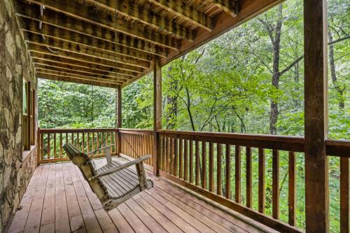 a porch of a cabin with a bench on it at Smoky Bears Creek by American Patriot Getaways in Line Spring
