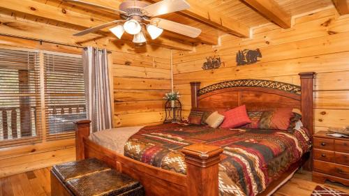 a bedroom with a bed and a ceiling fan at Smoky Mountain Escape by American Patriot Getaways in Henderson Springs