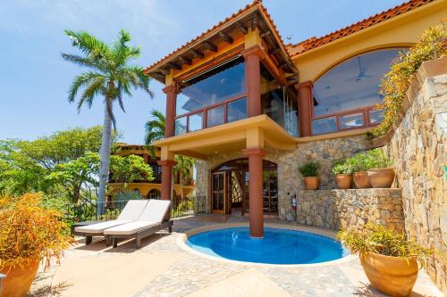 a house with a swimming pool in the backyard at Casa Ceiba Huatulco - Adults Only in Santa Cruz Huatulco