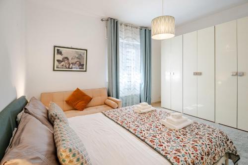 a bedroom with a large bed and a couch at Nonna Rosa (10 min to Pompei) in Trecase