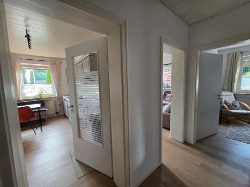 a living room with a door open to a living room at Ferienwohnung Am Bärenstein, Fränkische Schweiz in Gößweinstein