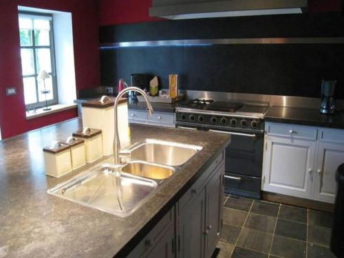 a kitchen with a sink and a stove at Spacious Place in Hamoir in Hamoir