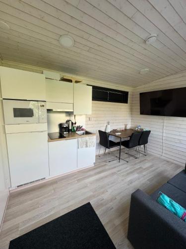 a kitchen and living room with a table and chairs at Cozy Guesthouse Liminka in Liminka