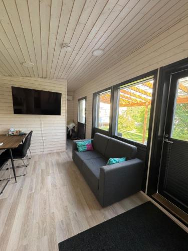 a living room with a couch and a table at Cozy Guesthouse Liminka in Liminka
