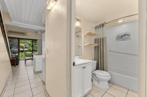 a bathroom with a toilet and a sink and a tub at Maui Vista 2422 in Kihei