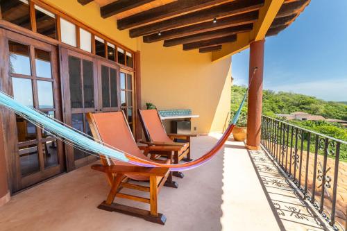 a hammock on the balcony of a house at Casa Ceiba Huatulco - Adults Only in Santa Cruz Huatulco