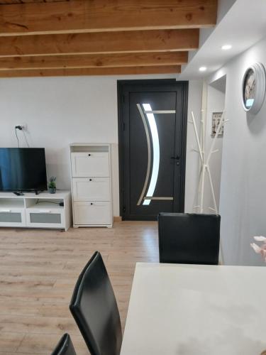 an office with a table and chairs and a door at Maison a louer in Donzère