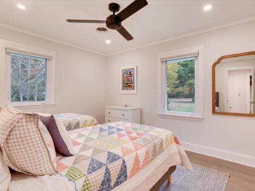a bedroom with a bed and a ceiling fan at Dragonfly Cove in Mount Pleasant