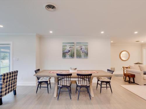 a dining room with a table and chairs at Dragonfly Cove in Mount Pleasant