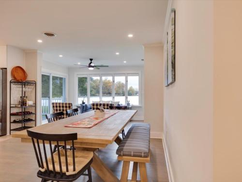 a kitchen and dining room with a wooden table and chairs at Dragonfly Cove in Mount Pleasant