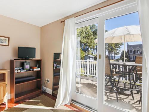 a living room with a sliding glass door leading to a patio at Crepe Myrtle in Tilghman