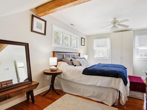 a bedroom with a large bed and a mirror at Crepe Myrtle in Tilghman