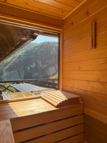 a room with a large window in a sauna at Mountain house Potkovica in Lazići