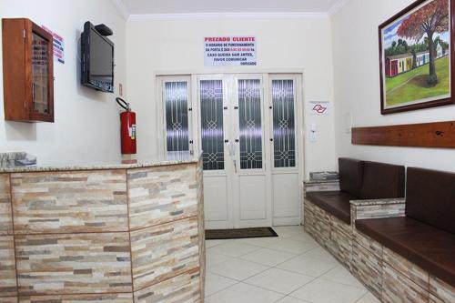 a waiting room with a fire hydrant and a fire extinguisheracistacistacist at Pousada Santa Rosa in Aparecida
