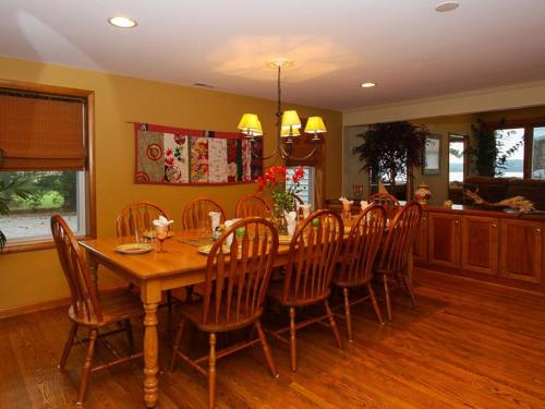 a dining room with a wooden table and chairs at Chesapeake Pines in Royal Oak