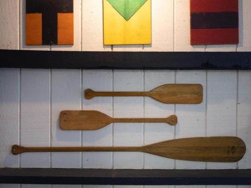two wooden spoons hanging on a wall with paintings at Captains Cove in Saint Michaels