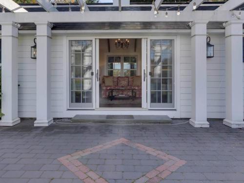 a front porch of a white house with a patio at Captains Cove in Saint Michaels