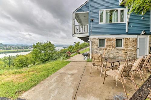 a house with chairs and a table on a patio at Cozy Stay 2min to DT Cincinnati & UC Medical Center in Cincinnati