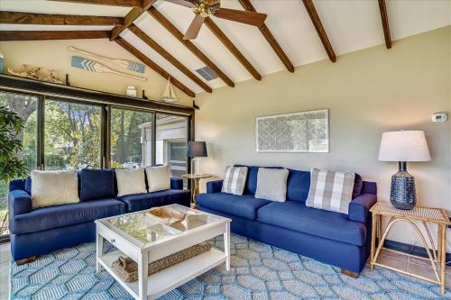 a living room with blue couches and a table at Leeds Landing in Saint Michaels