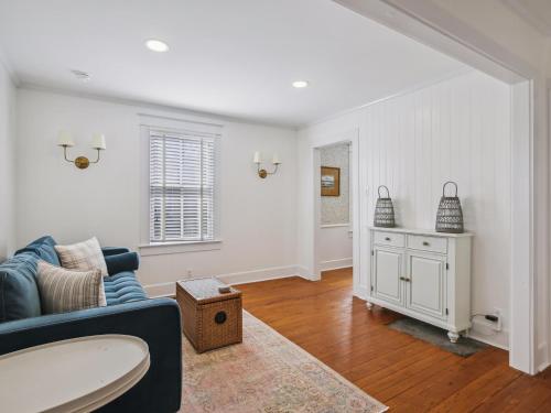 a living room with a blue couch and a table at Eventide of Oxford in Oxford