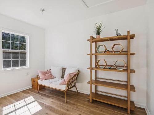 a living room with a couch and a shelf at Eventide of Oxford in Oxford