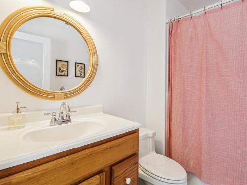 a bathroom with a sink and a toilet and a mirror at Eventide of Oxford in Oxford