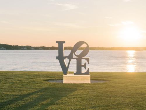 a sign in the grass next to a body of water at Fairview Estate in Saint Michaels