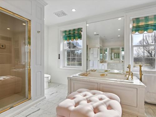 a white bathroom with a tub and a shower at Fairview Estate in Saint Michaels