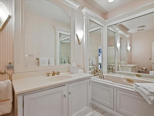 a white bathroom with a tub and a sink at Fairview Estate in Saint Michaels