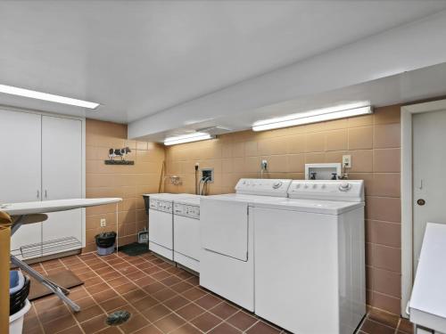 a laundry room with white washers and a counter at Fairview Estate in Saint Michaels