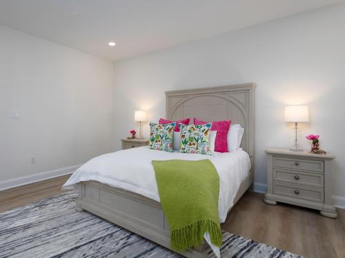 a bedroom with a bed with a green blanket on it at Namaste on the Bay in Stevensville