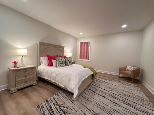 a bedroom with a bed and a table and a chair at Namaste on the Bay in Stevensville