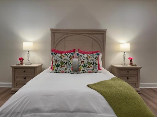 a bedroom with a large bed with two night stands at Namaste on the Bay in Stevensville