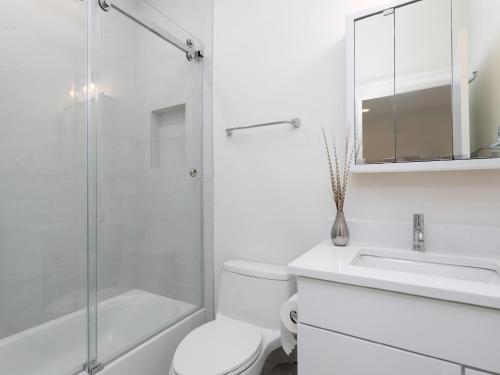 a bathroom with a toilet and a sink and a shower at Namaste on the Bay in Stevensville