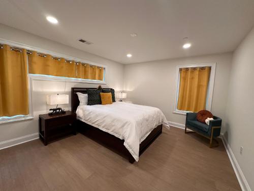 a bedroom with a bed and a chair at Namaste on the Bay in Stevensville
