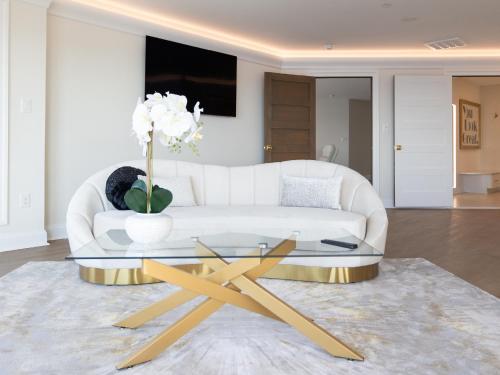 a living room with a white couch and a glass table at Namaste on the Bay in Stevensville