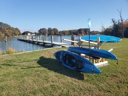 a blue kayak sitting on the grass near the water at Lighthouse Haven in Paradise Island