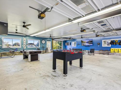 a room with a ping pong table and pool tables at Lighthouse Haven in Paradise Island