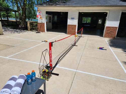 a tennis court with a net in front of a building at Lighthouse Haven in Paradise Island