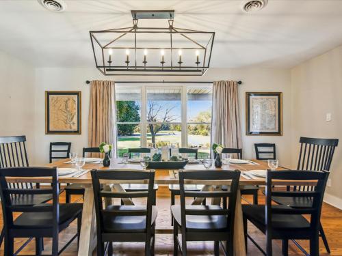 a dining room with a table and chairs and a chandelier at Lighthouse Haven in Paradise Island