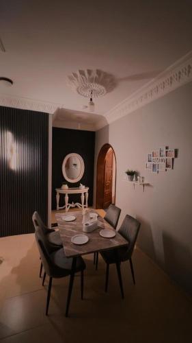 a dining room with a wooden table and chairs at شقة الخالدية 1 in Al Madinah